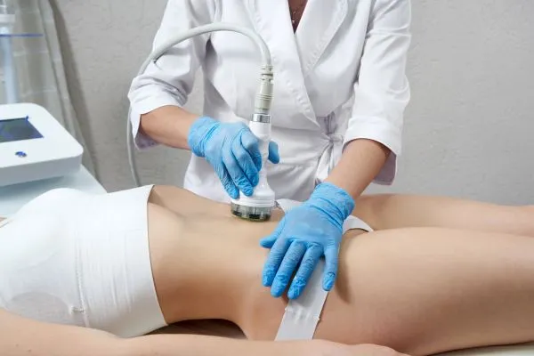 Lost the Weight but Not the Loose Skin? 2 woman having HIFU treatment on her stomach to combat loose skin Bicester following weight loss